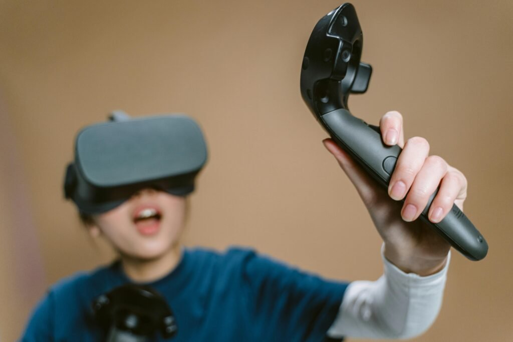 Enthusiastic woman using VR headset and controller indoors.